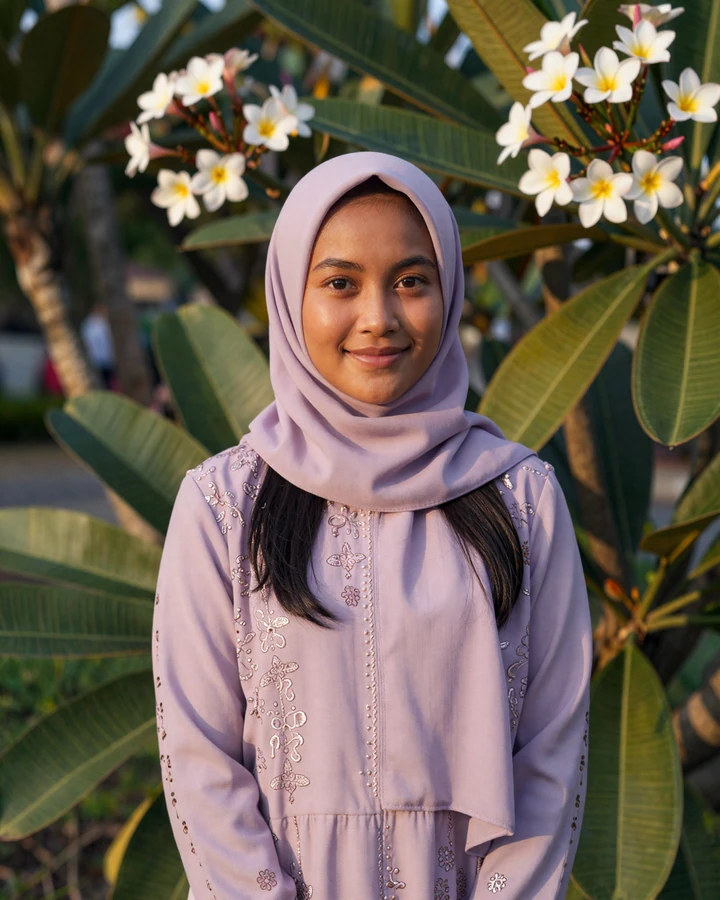 Verified Bruneian woman member smiling in tropical garden on QualityDatingAdvice dating platform